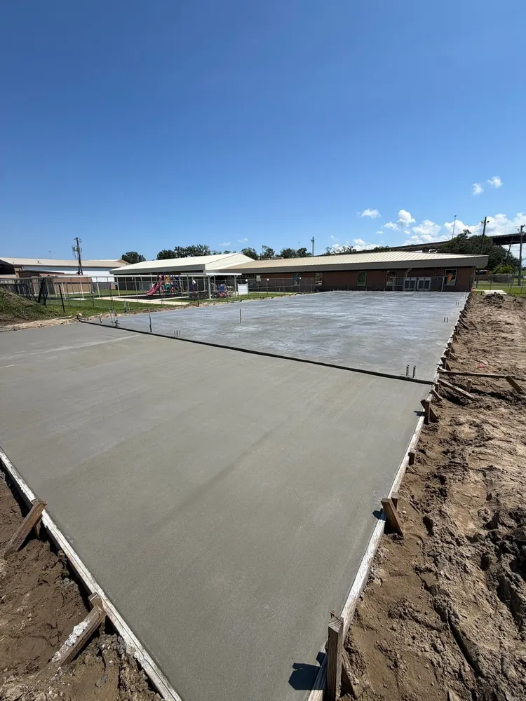Fresh concrete slab areas with perimeter forms.